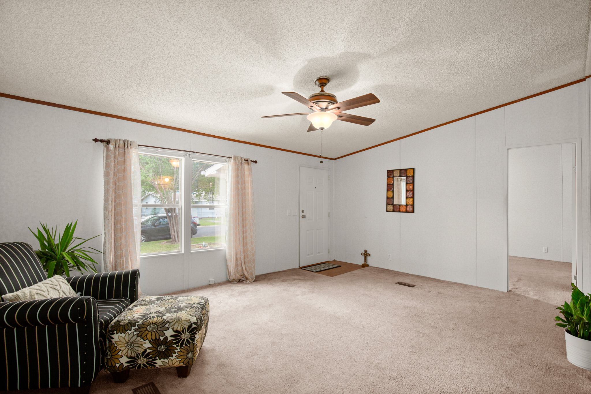 1104 Vasquez Street Austin, TX 78741 - Photo 5 of 18 a view of a livingroom with a chandelier fan and windows
