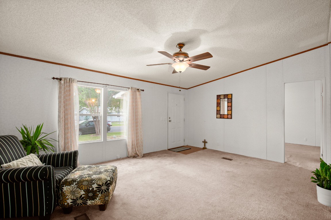 1104 Vasquez Street Austin, TX 78741 - Photo 5 of 18 a view of a livingroom with a chandelier fan and windows