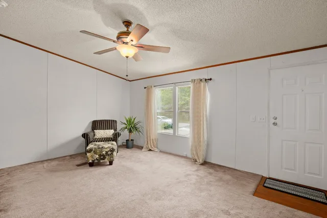 a view of livingroom with furniture and ceiling fan