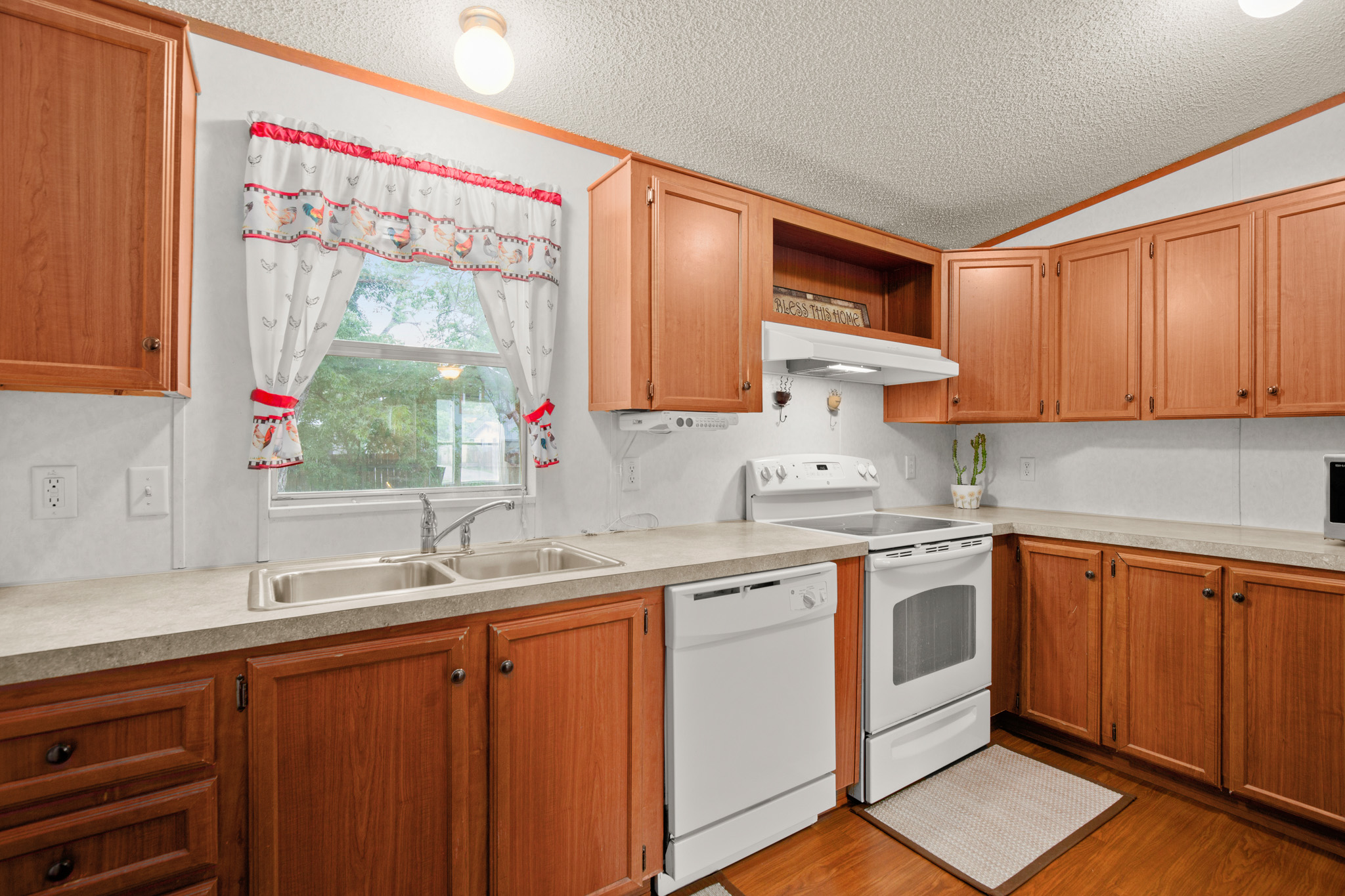 1104 Vasquez Street Austin, TX 78741 - Photo 8 of 18 a kitchen with stainless steel appliances sink cabinets and window