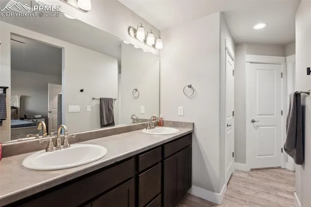 a bathroom with a double vanity sink and a mirror