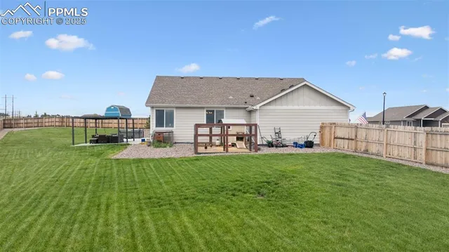 an aerial view of a house with a garden and lake view