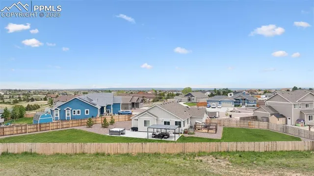 a aerial view of a house with a yard
