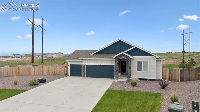 a front view of a house with a yard table and chairs