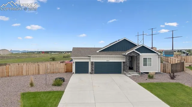 a front view of a house with a yard and a garage