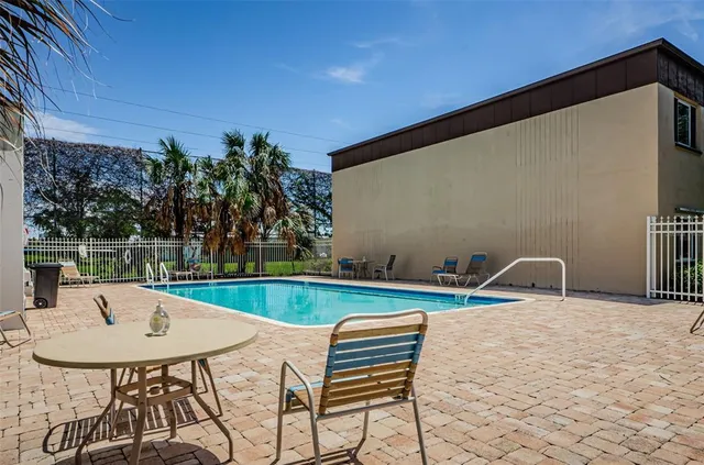 a view of patio with a table and chairs