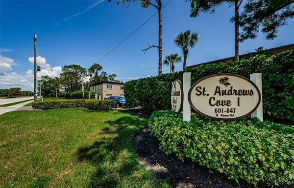 a view of a sign in a yard with potted plants
