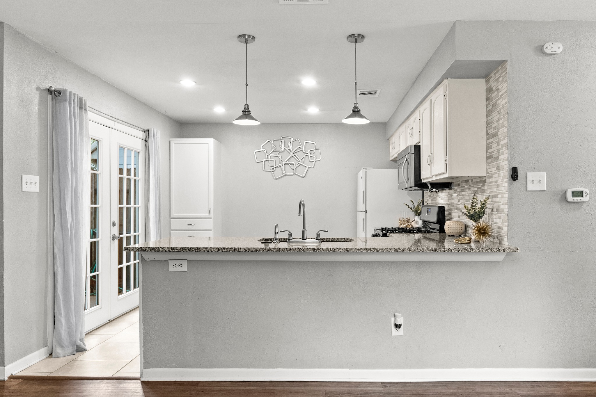 8330 Fathom Circle, Unit 501 Austin, TX 78750 - Photo 6 of 26 a kitchen with kitchen island a sink and wooden floor