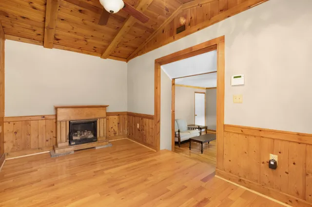 a view of a big room with wooden floor and windows