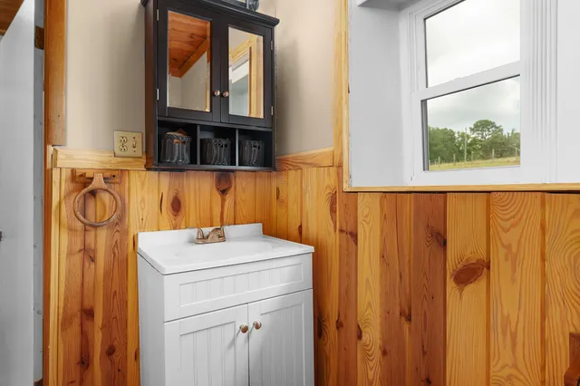 a bathroom with a glass shower door