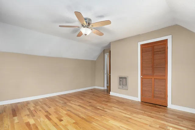 a view of backyard with wooden deck and floor to ceiling window