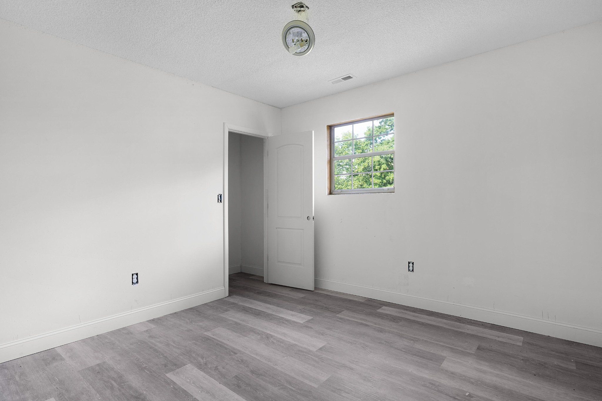 930 Kensington Road Chickamauga, GA 30707 - Photo 61 of 82 an empty room with wooden floor and windows