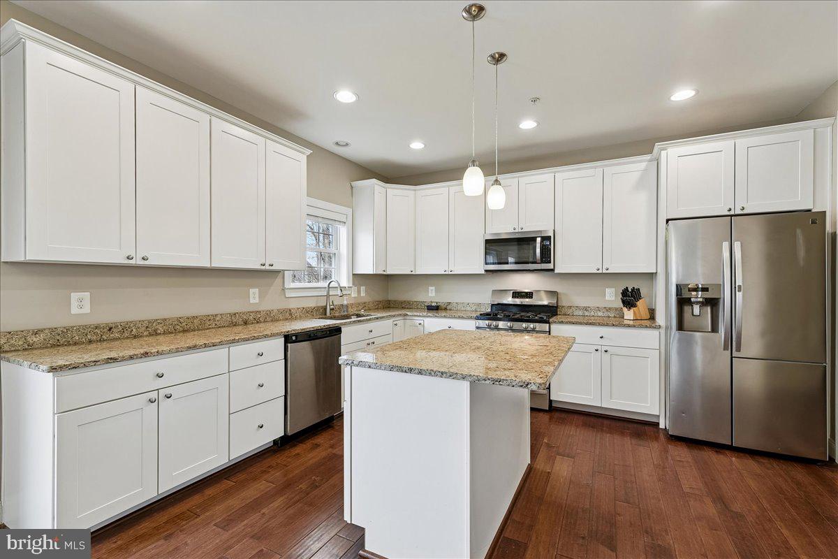 7526 Gilley Terrace Rosedale, MD 21237 - Photo 11 of 43 a kitchen with granite countertop white cabinets and stainless steel appliances