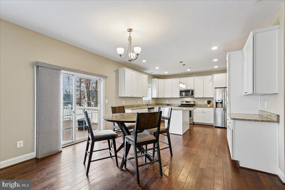 7526 Gilley Terrace Rosedale, MD 21237 - Photo 15 of 43 a view of a dining room with furniture and wooden floor
