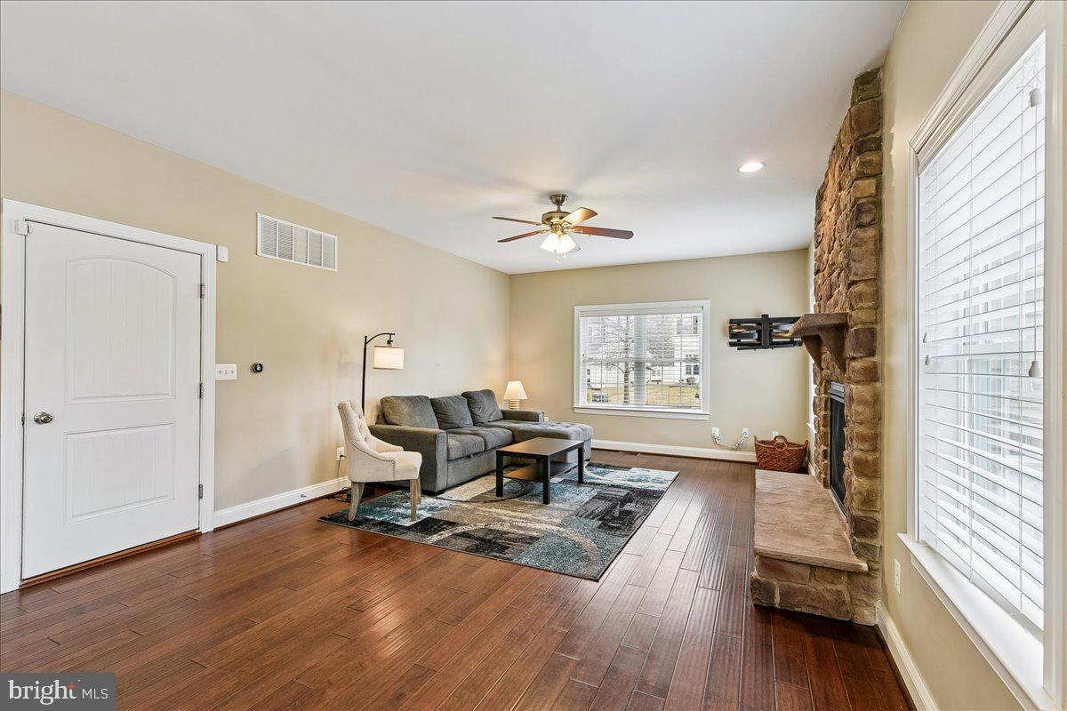 7526 Gilley Terrace Rosedale, MD 21237 - Photo 17 of 43 a living room with furniture and a wooden floor