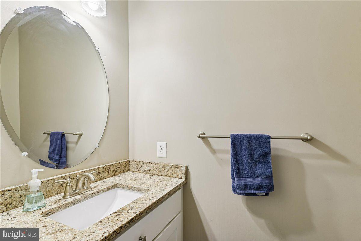 7526 Gilley Terrace Rosedale, MD 21237 - Photo 19 of 43 a bathroom with a granite countertop sink and a mirror