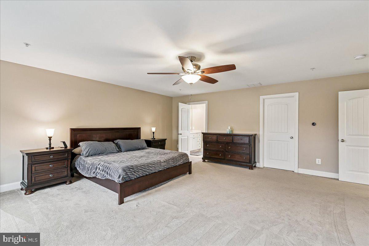 7526 Gilley Terrace Rosedale, MD 21237 - Photo 23 of 43 a spacious bedroom with a bed and a ceiling fan