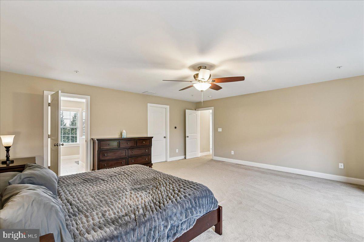 7526 Gilley Terrace Rosedale, MD 21237 - Photo 24 of 43 a bedroom with a bed and a chandelier