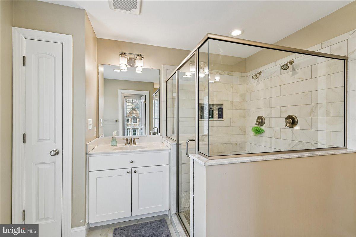 7526 Gilley Terrace Rosedale, MD 21237 - Photo 26 of 43 a bathroom with a shower sink and mirror