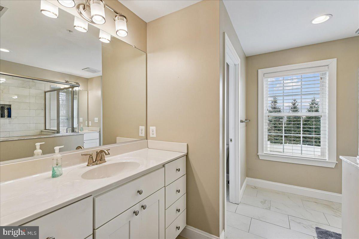 7526 Gilley Terrace Rosedale, MD 21237 - Photo 27 of 43 a bathroom with a sink double vanity and a mirror