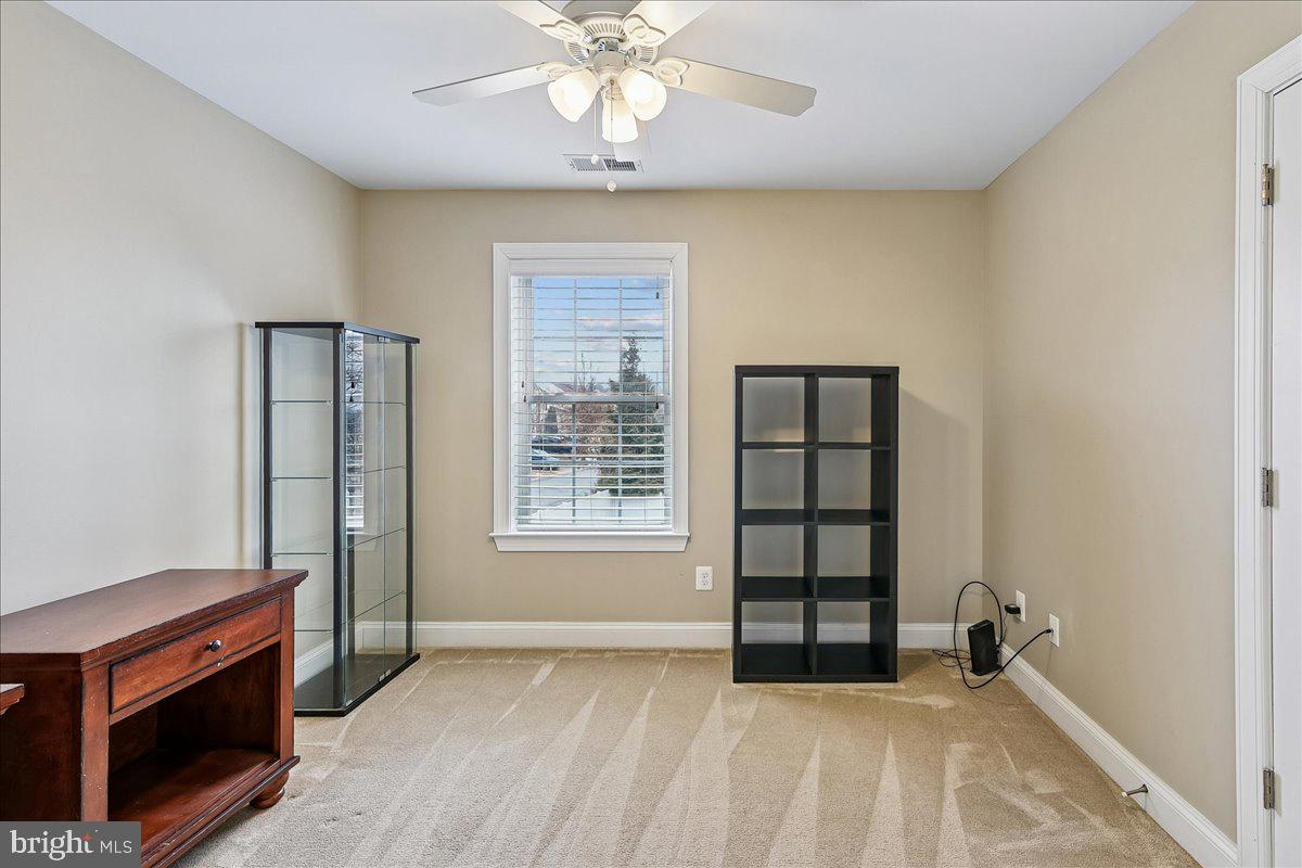 7526 Gilley Terrace Rosedale, MD 21237 - Photo 33 of 43 an empty room with a fireplace and windows