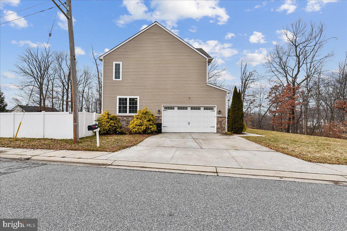 7526 Gilley Terrace Rosedale, MD 21237 - Photo 42 of 43 a front view of a house with a yard and garage