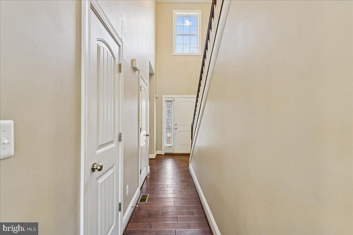 7526 Gilley Terrace Rosedale, MD 21237 - Photo 7 of 43 a view of a hallway with wooden floor and staircase