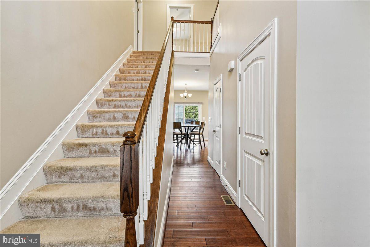 7526 Gilley Terrace Rosedale, MD 21237 - Photo 8 of 43 a view of a hallway with wooden floor and staircase