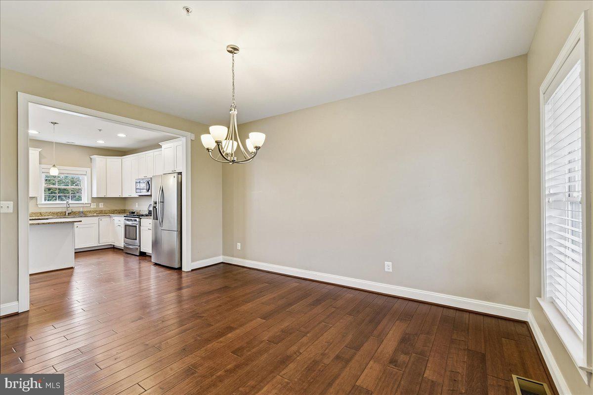 7526 Gilley Terrace Rosedale, MD 21237 - Photo 9 of 43 a view of a kitchen with a dishwasher cabinets and a floor to ceiling window