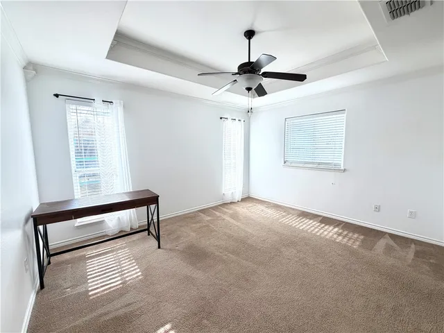 a view of workspace with window and a ceiling fan