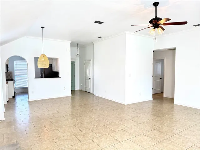 a view of a room with a stylish ceiling fan and entryway