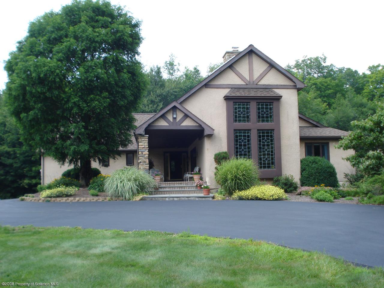72 Memory Lane Moscow, PA 18444 - Photo 1 of 34 a front view of a house with a yard and garage