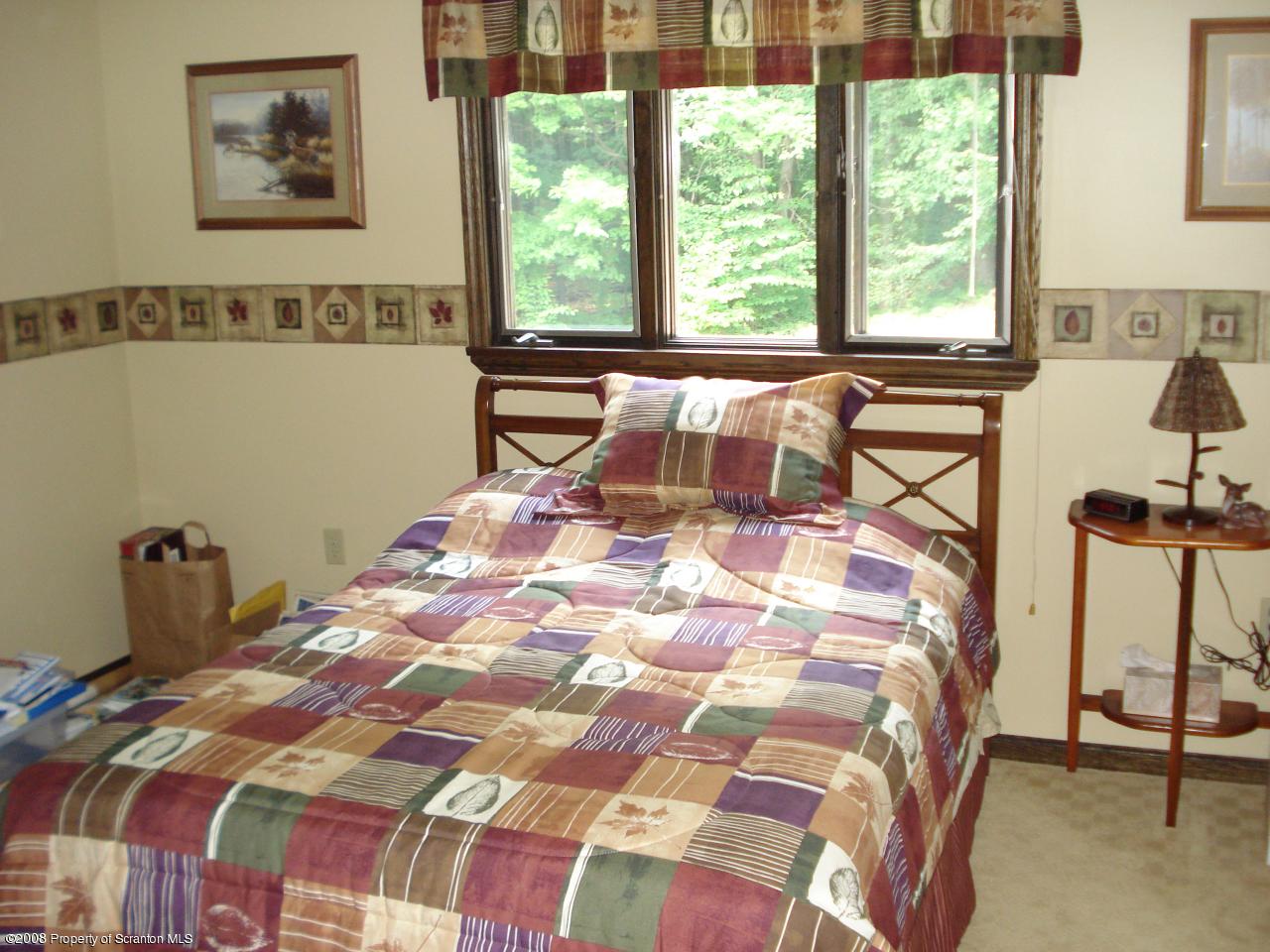 72 Memory Lane Moscow, PA 18444 - Photo 20 of 34 a bedroom with a bed and a window