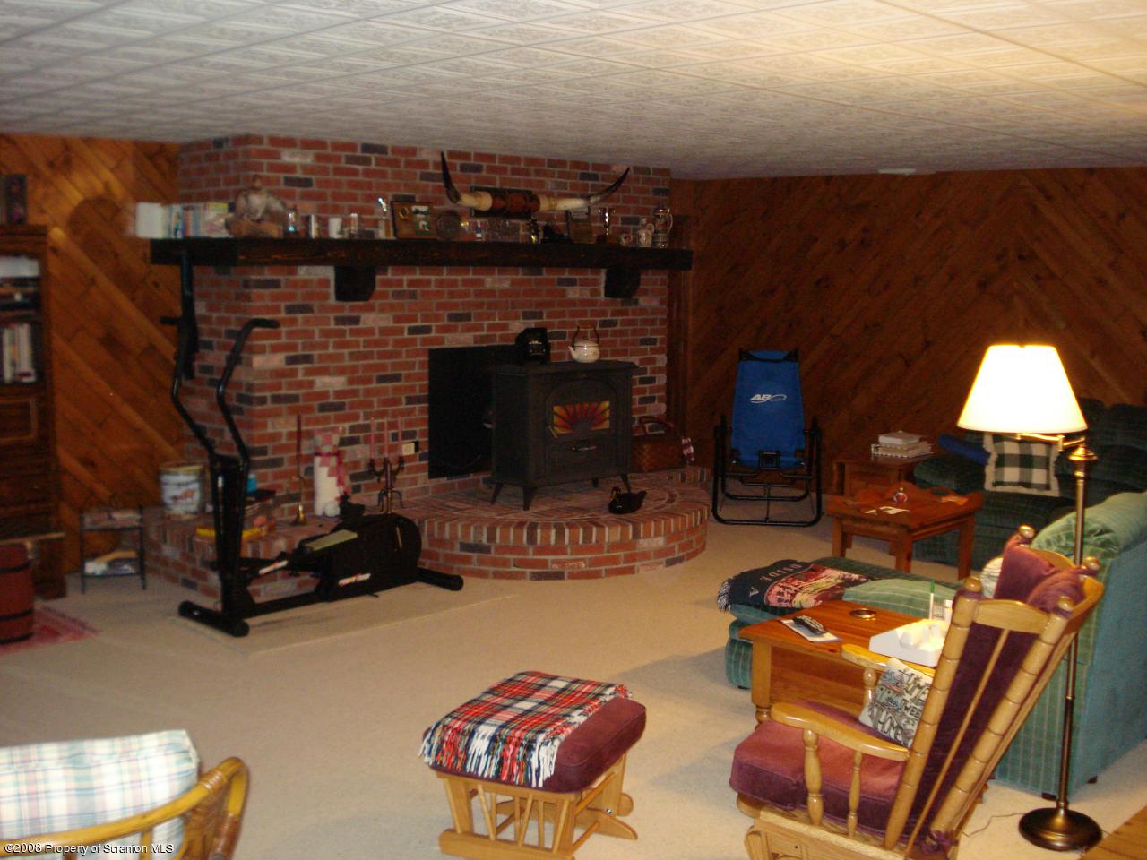 72 Memory Lane Moscow, PA 18444 - Photo 33 of 34 a living room with furniture a fireplace and a table