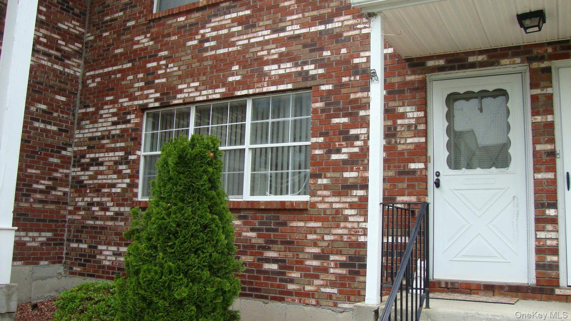 276 Temple Hill Road, Unit 2215 New Windsor, NY 12553 - Photo 2 of 16 a front view of a building with a tree