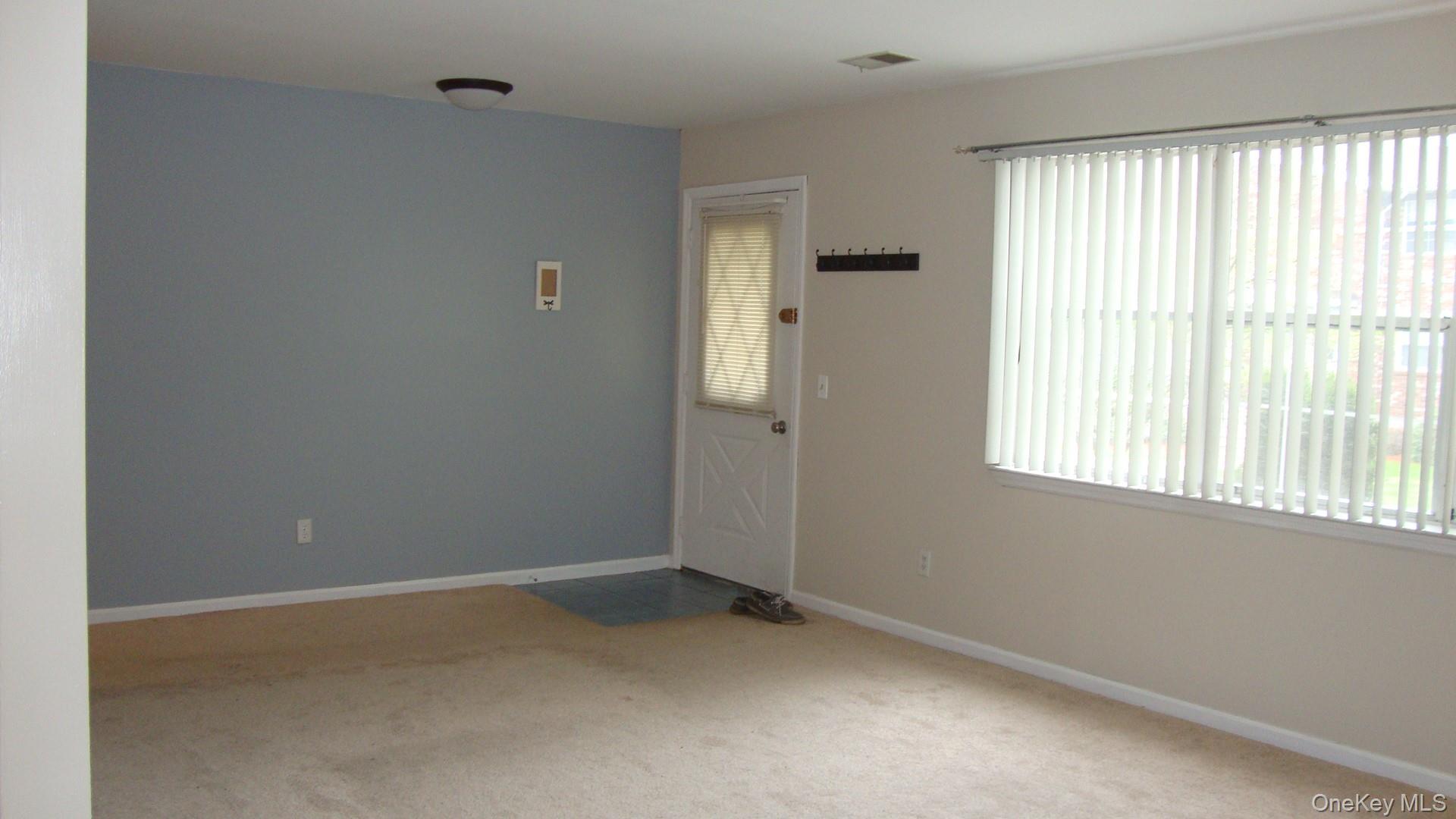 276 Temple Hill Road, Unit 2215 New Windsor, NY 12553 - Photo 4 of 16 a view of an empty room with a window