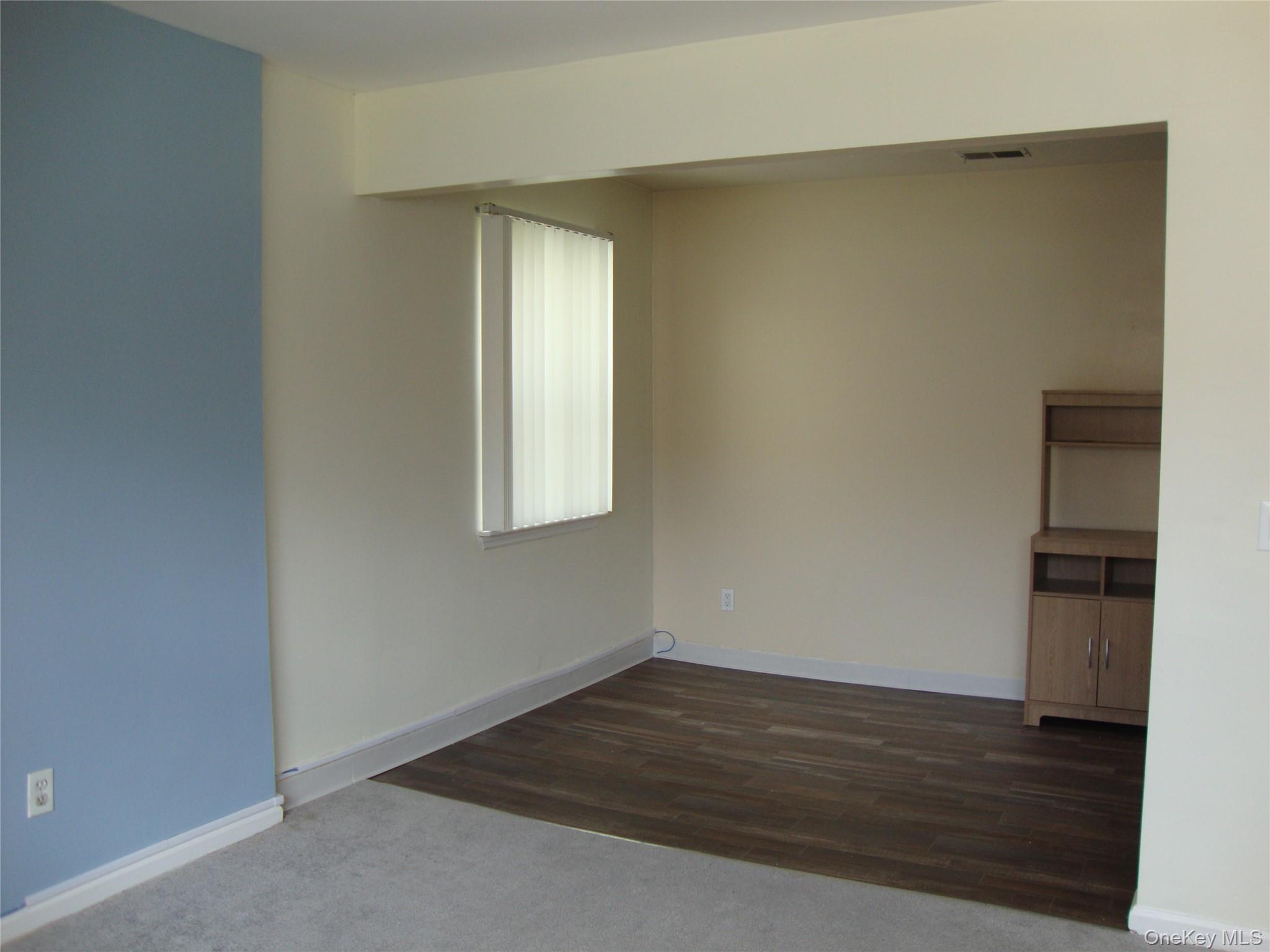 276 Temple Hill Road, Unit 2215 New Windsor, NY 12553 - Photo 6 of 16 an empty room with wooden floor and windows