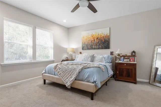 a spacious bedroom with a bed and a window