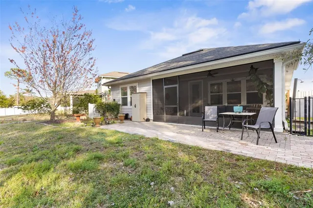 a view of a house with backyard porch and sitting area
