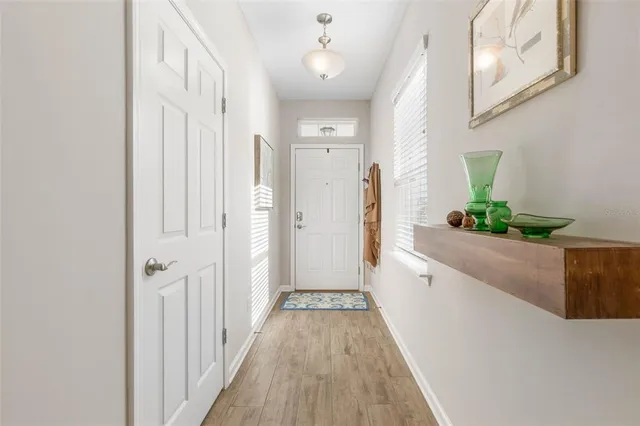 a view of a hallway with wooden floor and staircase