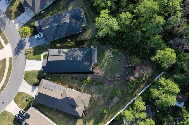 an aerial view of a house with a yard
