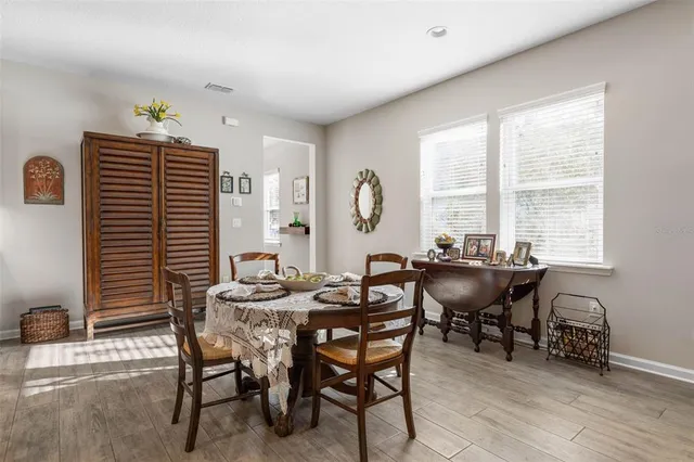 a view of a dining room with furniture and chandelier