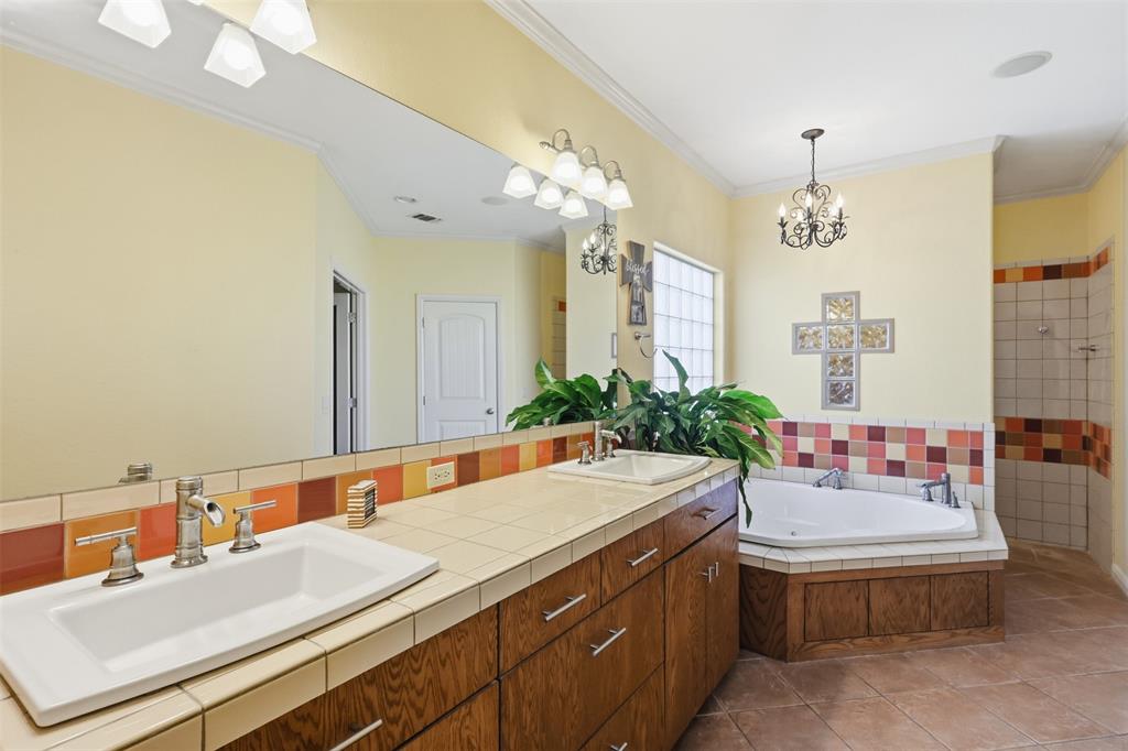 207 Dennis Road Lipan, TX 76462 - Photo 20 of 40 Dual vanity with wood-finish cabinetry, tile countertop, and rectangular undermount sinks