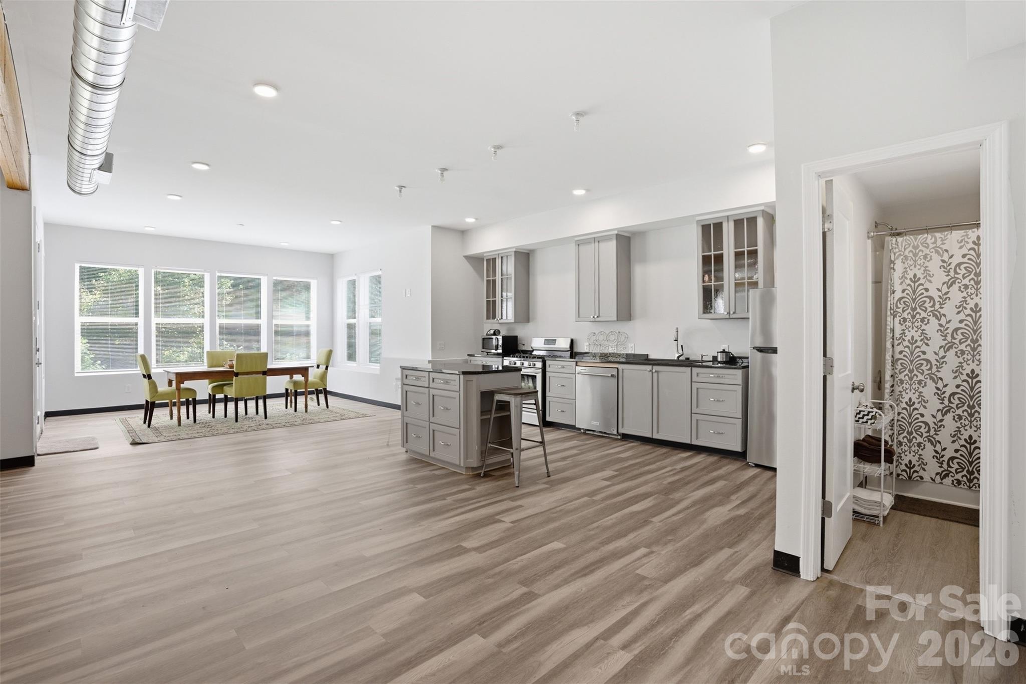 14022 Salem Ridge Road Huntersville, NC 28078 - Photo 28 of 38 a open kitchen with white cabinets and stainless steel appliances