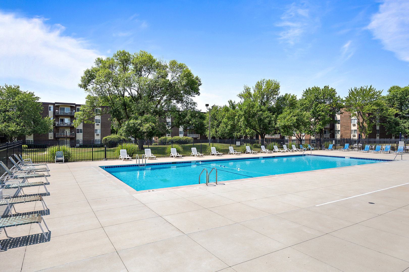 1311 South Finley Road, Unit 205 Lombard, IL 60148 - Photo 18 of 26 a view of swimming pool with seating space and trees in the background