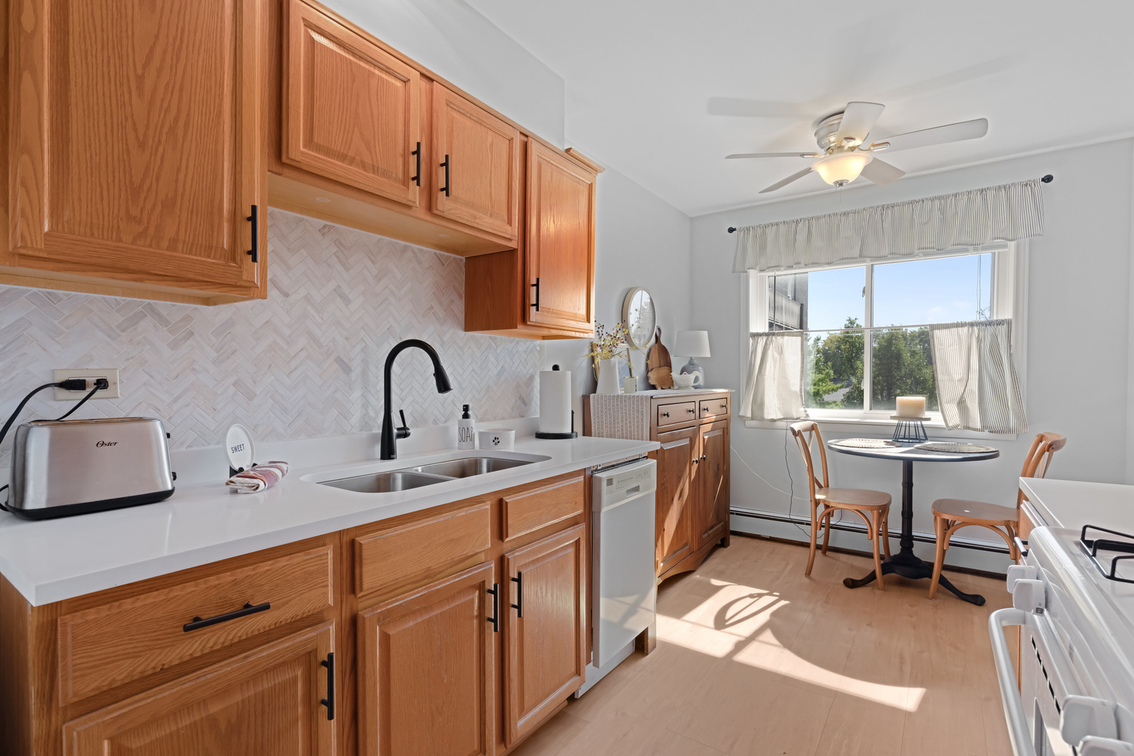 1311 South Finley Road, Unit 205 Lombard, IL 60148 - Photo 8 of 26 a kitchen with a sink cabinets and window