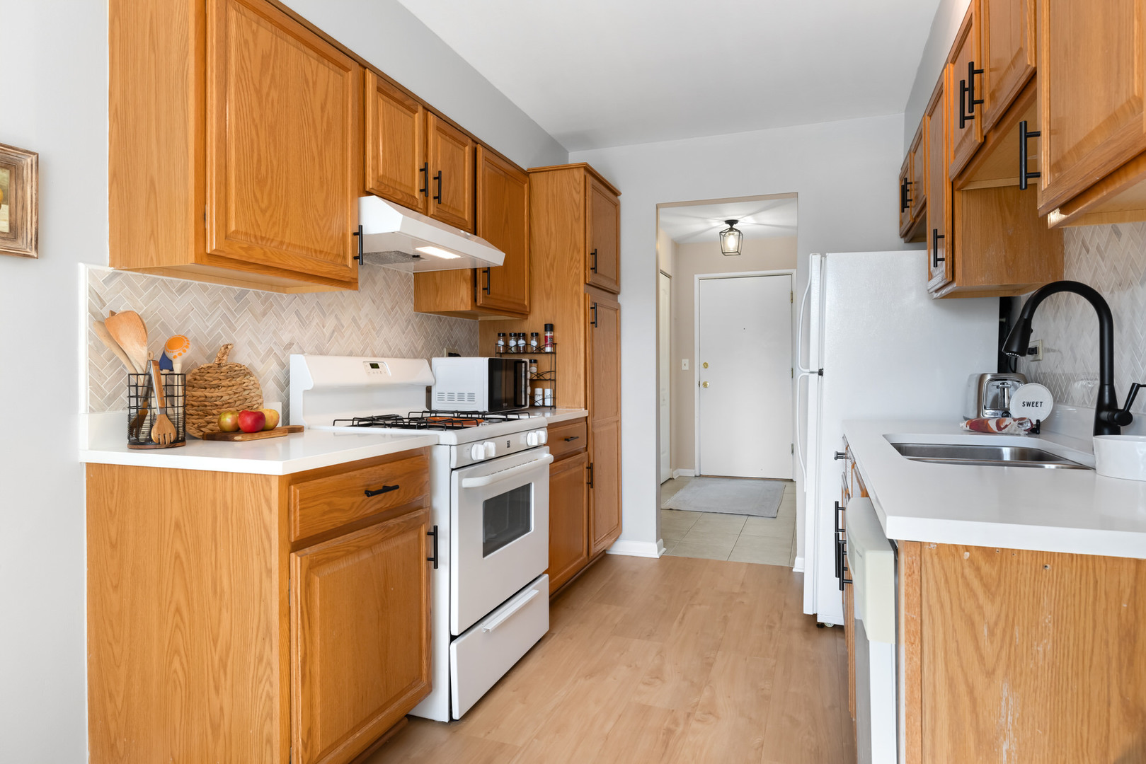 1311 South Finley Road, Unit 205 Lombard, IL 60148 - Photo 10 of 26 a kitchen with stainless steel appliances granite countertop a sink stove and refrigerator