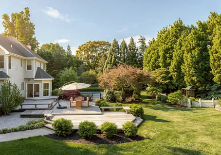 a view of a house with swimming pool and sitting area