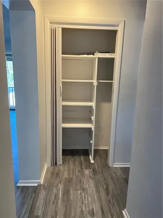 a room with a closet and wooden floor