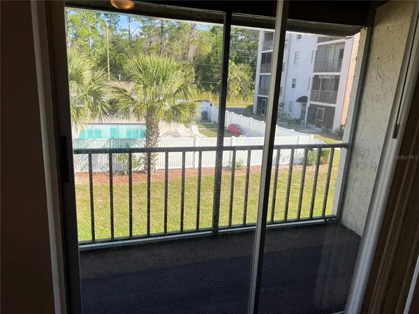 a view of a glass door with a balcony